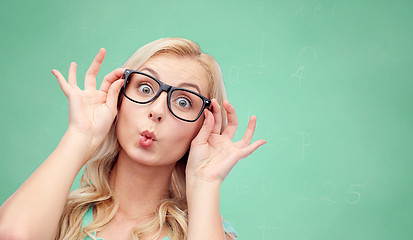 Image showing happy young woman in glasses making fish face