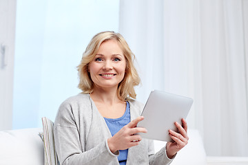 Image showing happy middle aged woman with tablet pc at home