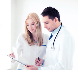 Image showing two doctors writing prescription