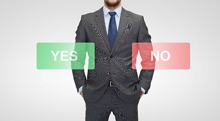 Image showing close up of businessman with yes and no buttons