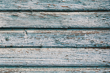 Image showing Old blue cracked paint on wooden background