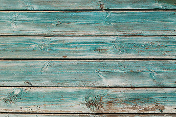 Image showing Old blue cracked paint on wooden background