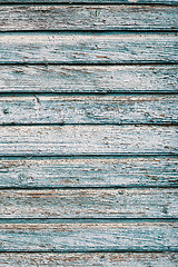 Image showing Old blue cracked paint on wooden background