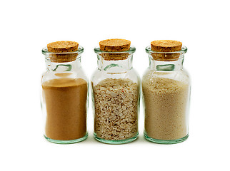 Image showing three glass bottles filled with sand