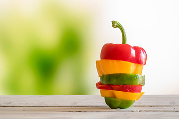 Image showing Pepper stacked on a wooden table