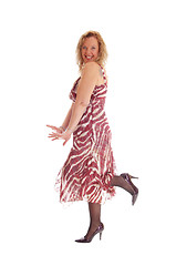 Image showing Happy blond woman dancing in dress.