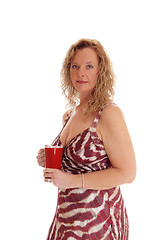 Image showing Blond woman with red coffee mug.