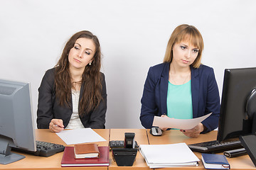 Image showing Employees of the office sitting at a desk with a view of the downtrodden