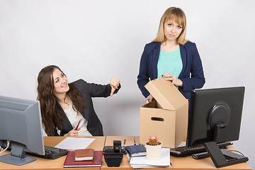 Image showing Office woman with a humiliating gesture unsettled the dismissed colleague