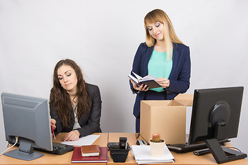 Image showing An employee in the office happily lays out things about colleagues