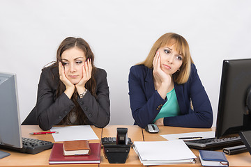 Image showing  Two young office worker tired of sitting in front of computers