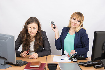 Image showing Positive girl in the office with a phone in his hand close to the negative counterpart