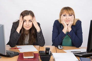 Image showing Two office employee sitting with depressed and frightened look