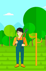 Image showing Farmer with pruner in garden.