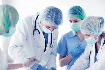 Image showing young group of doctors doing operation