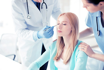Image showing male plastic surgeon with patient