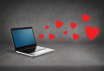 Image showing laptop with blank screen and red hearts