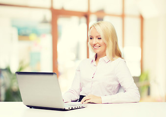 Image showing smiling businesswoman or student with laptop