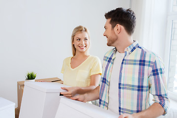 Image showing smiling couple with big boxes moving to new home