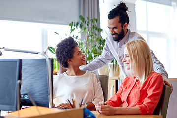 Image showing happy creative team with computer in office