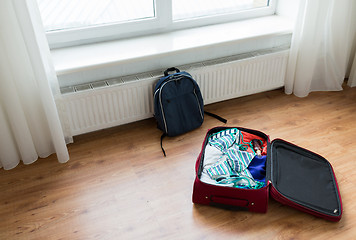 Image showing close up of travel bag with clothes and backpack