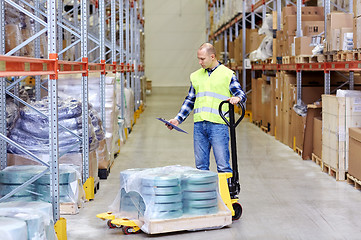 Image showing man with loader and clipboard at warehouse