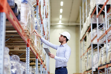 Image showing businessman with tablet pc at warehouse