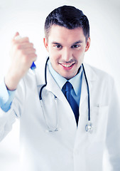 Image showing evil doctor holding syringe with injection