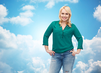 Image showing smiling young woman in shirt and jeans