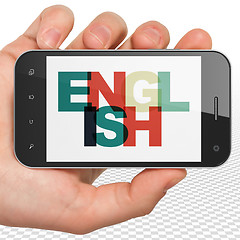 Image showing Studying concept: Hand Holding Smartphone with English on  display