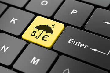 Image showing Safety concept: Money And Umbrella on computer keyboard background