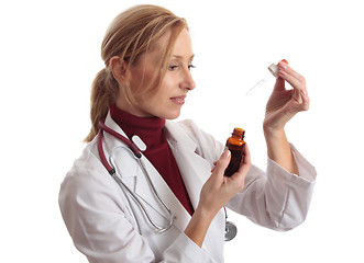 Image showing Doctor naturapath with eyedropper and  bottle