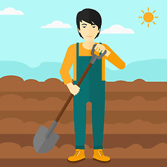 Image showing Farmer on the field with shovel.