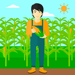 Image showing Farmer holding corn.