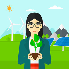 Image showing Woman holding plant.