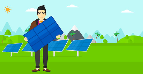 Image showing Man holding solar panel.