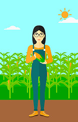 Image showing Farmer holding corn.