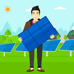 Image showing Man holding solar panel.