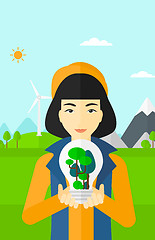 Image showing Woman with lightbulb and trees inside.