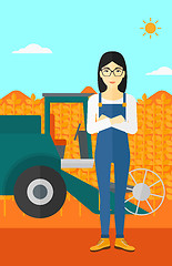 Image showing Woman standing with combine on background.