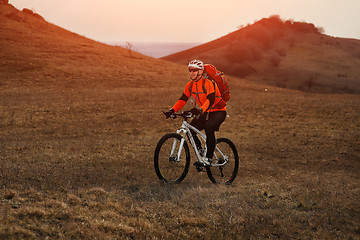 Image showing Man cyclist with backpack riding the bicycle