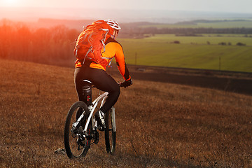 Image showing Man cyclist with backpack riding the bicycle