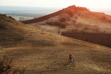 Image showing Man cyclist with backpack riding the bicycle