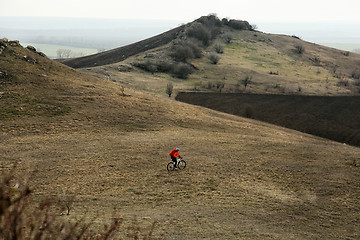 Image showing Man cyclist with backpack riding the bicycle