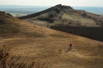 Image showing Man cyclist with backpack riding the bicycle