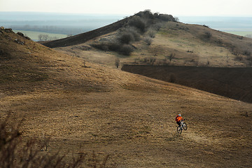 Image showing Man cyclist with backpack riding the bicycle