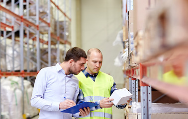 Image showing worker and businessmen with clipboard at warehouse