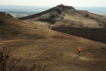 Image showing Man cyclist with backpack riding the bicycle