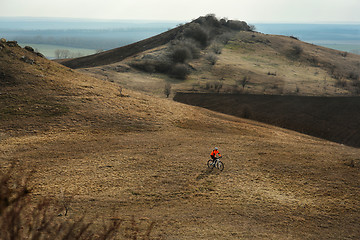 Image showing Man cyclist with backpack riding the bicycle