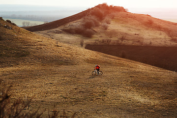 Image showing Man cyclist with backpack riding the bicycle